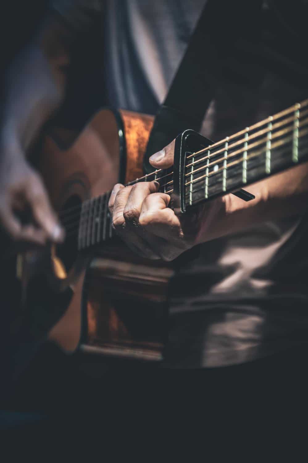 man-plays-acoustic-guitar-closeup
